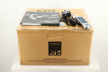 Box of a used ATC SIA2-100 Integrated Amplifier in Silver finish showing mains cable, manual, and remote