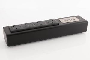 Rear right corner of a used Atlas EOS Modular 4-Way Mains Block in a Black finish