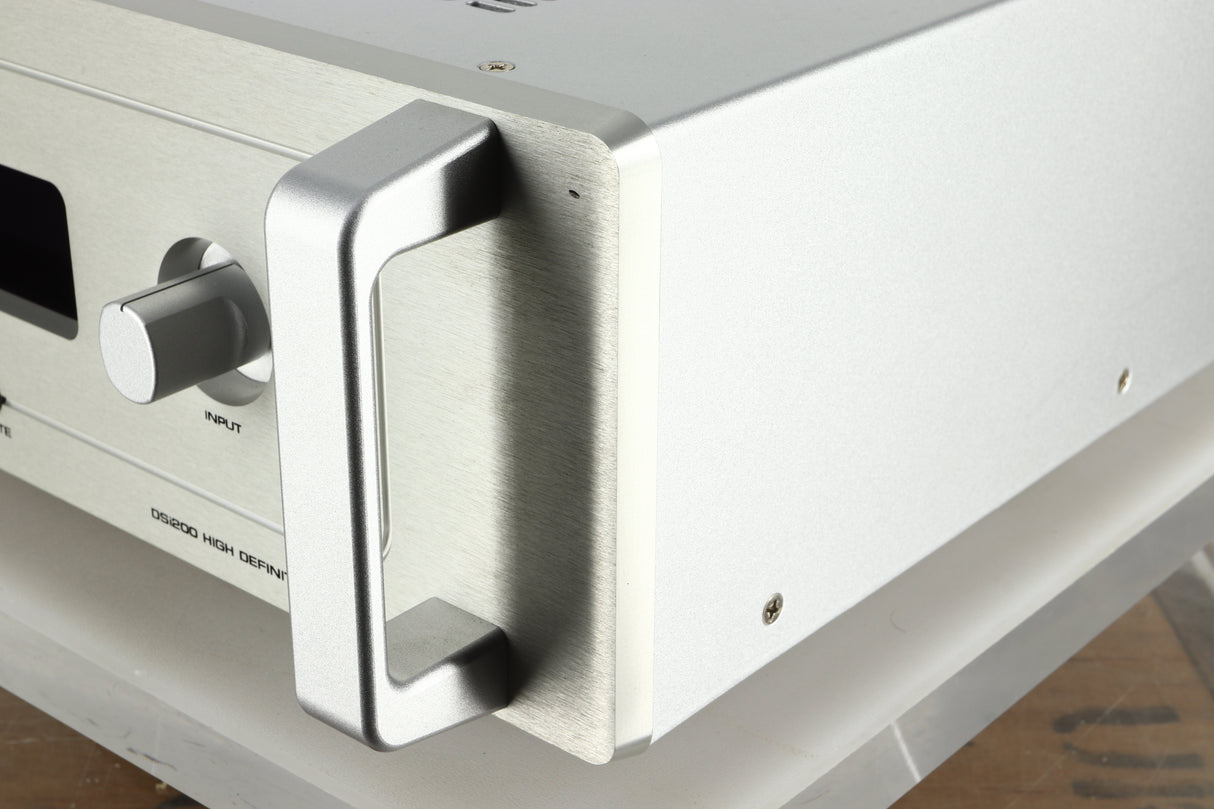 Front right corner view of a used Audio Research DSi200 Integrated Amplifier in silver finish showing a small dent on the top right of the fascia