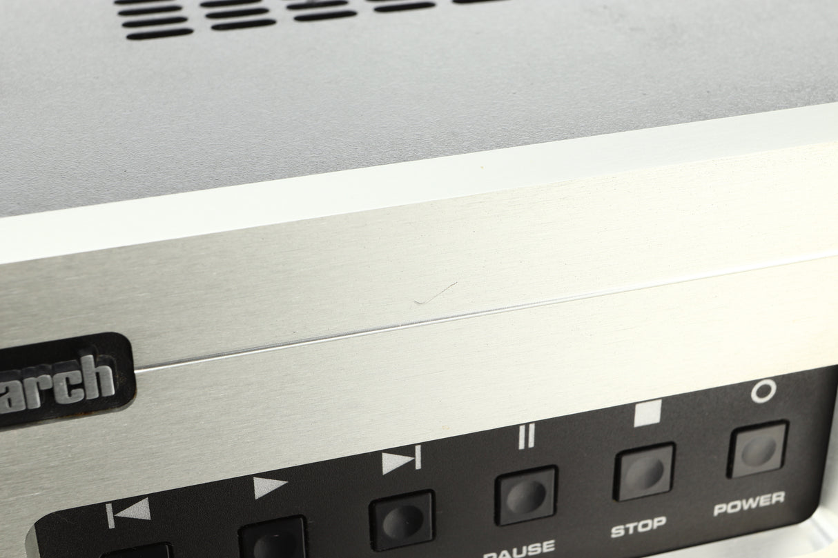 Close up view of a used Audio Research Reference CD8 CD Player in silver finish  showing a small scratch on the fascia above the play and pause buttons