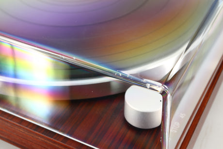 Close up view of a used Audio Technica AT-LPW50BT Turntable in Rosewood finish showing damage to the front left corner of the lid