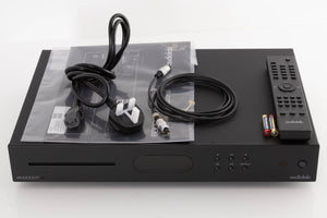 Top of a used Audiolab 6000CDT CD Transport in a Black finish showing Remote, Batteries, Mains Cable, Manual and Optical Cable