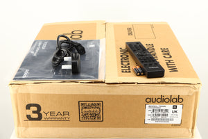 Box for a used Audiolab 7000A Integrated Amplifier in a black finish showing Remote, 2x Batteries, Manual and Mains Cable