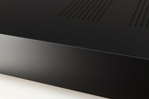 Close up of a used Audiolab 7000A Integrated Amplifier in a black finish showing white scratch on top
