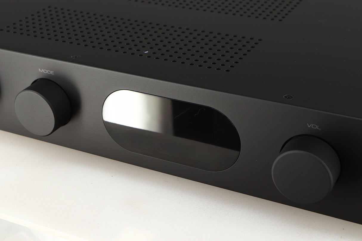 Close up of a used Audiolab 7000A Integrated Amplifier in a black finish showing scratches on screen