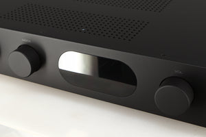 Close up of a used Audiolab 7000A Integrated Amplifier in a black finish showing scratches on screen