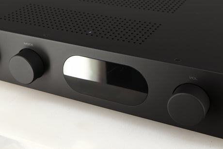 Close up of a used Audiolab 7000A Integrated Amplifier in a black finish showing scratches on screen