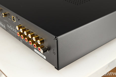Rear left corner of a used Audiolab 7000A Integrated Amplifier in a black finish