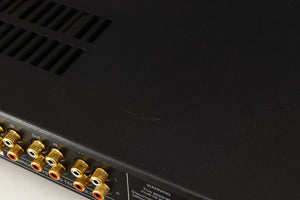 Close up of a used Audiolab 8000A Integrated Amplifier in a black finish showing scratching on top
