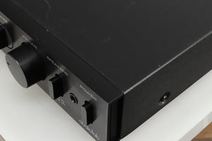 Close up of a used Audiolab 8000A Integrated Amplifier in a black finish showing some damage