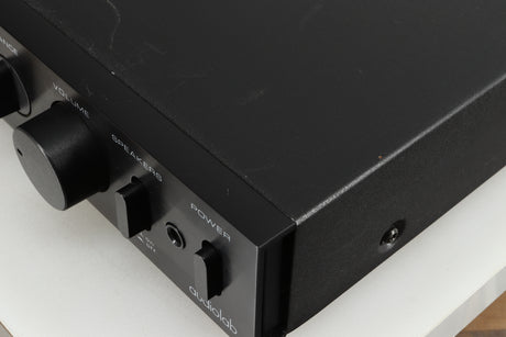 Close up of a used Audiolab 8000A Integrated Amplifier in a black finish showing some damage