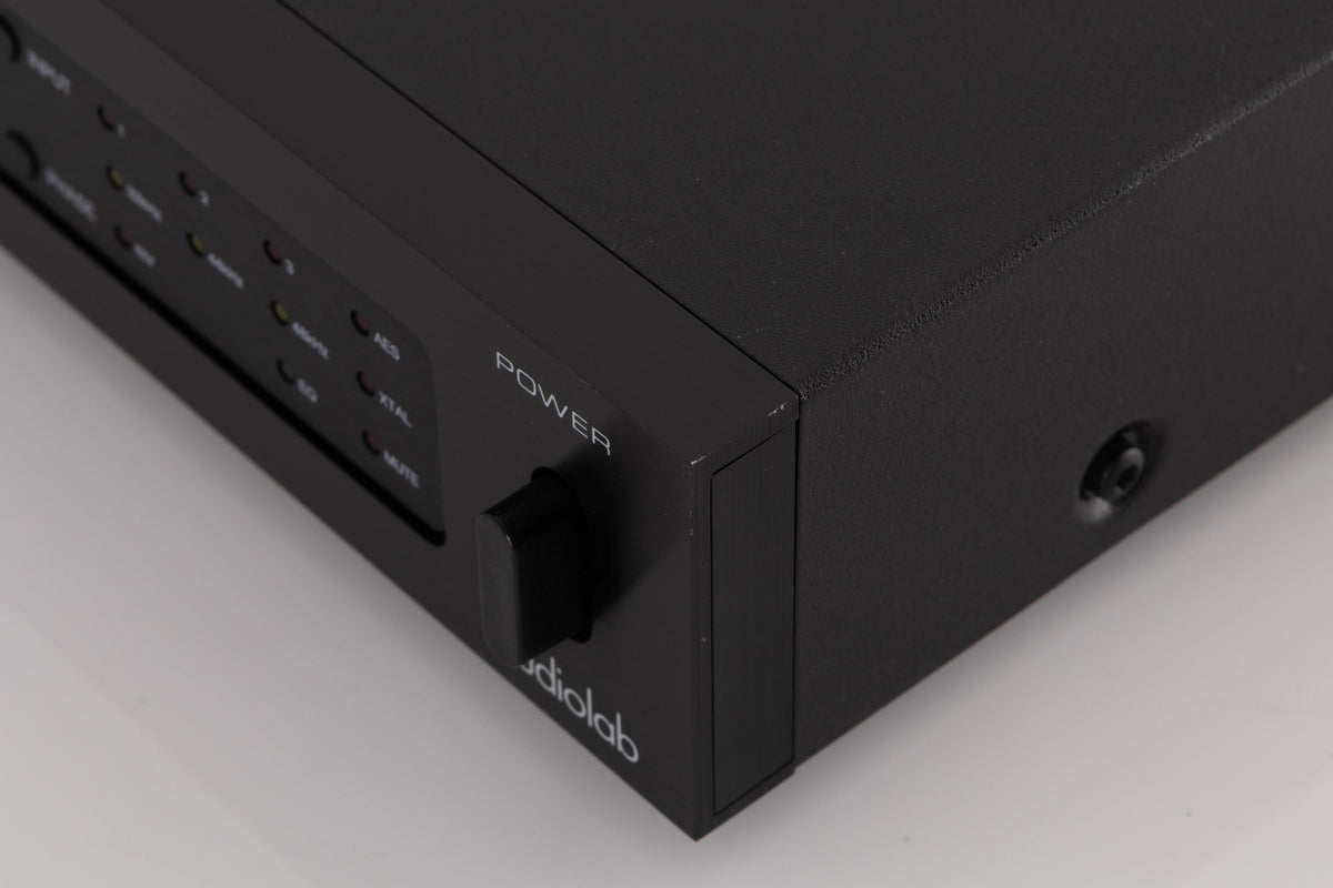 Front right corner of a used Audiolab 8000DAC Digital Analogue Converter in a Black finish