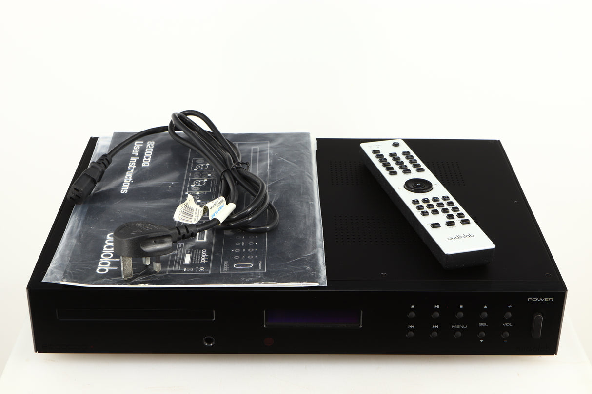 Top of a used Audiolab 8200CDQ CD Player in a black finish showing Mains Cable, Remote and Manual
