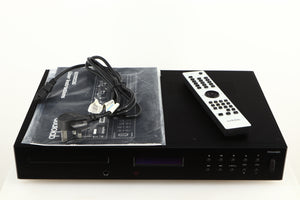 Top of a used Audiolab 8200CDQ CD Player in a black finish showing Mains Cable, Remote and Manual