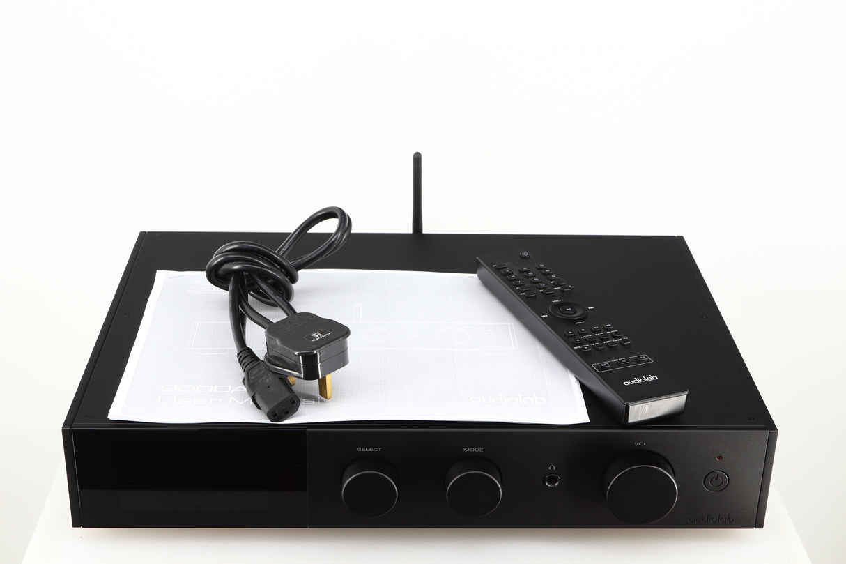 Top of a used Audiolab 9000A Integrated Amplifier in a black finish showing Mains Cable, Manual and Remote