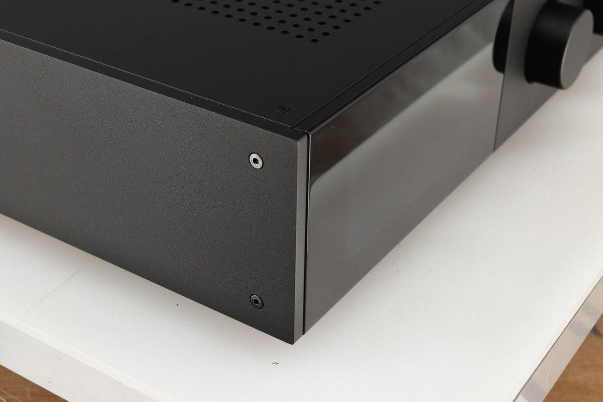 Front left corner of a used Audiolab 9000A Integrated Amplifier in a black finish