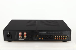 Rear view of a used Audiolab 9000A Integrated Amplifier in a black finish showing Phono Inputs and Outputs, Mains Input, Speaker Output and Optical Input