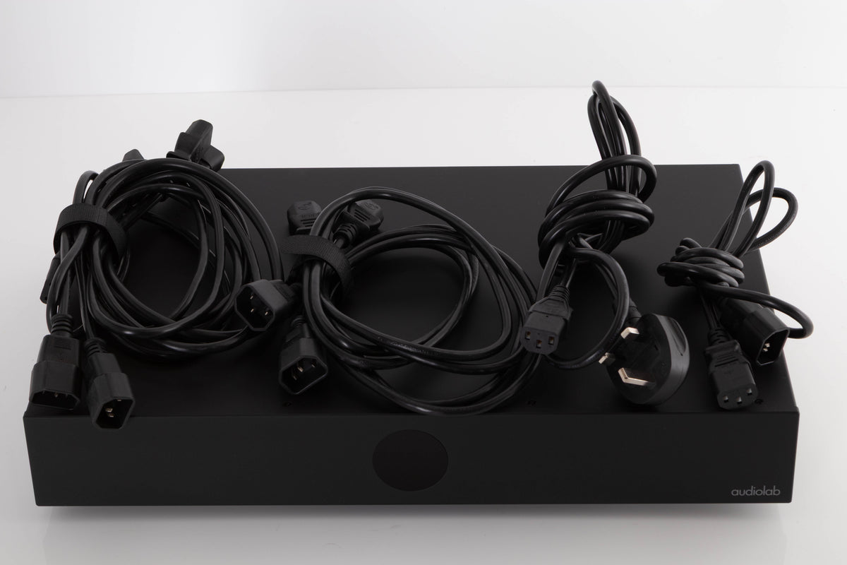 Top of a used Audiolab DC Block 6 in a Black finish showing Power Cables and Mains Cable