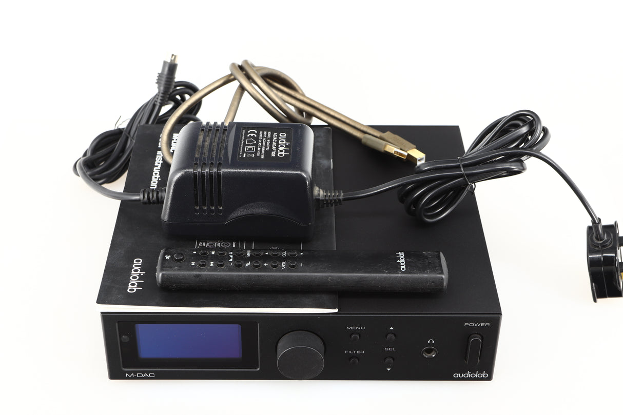 Top of a used Audiolab M-DAC Digital Analogue Converter in a black finish showing Remote, PSU, Manual and USB Cable