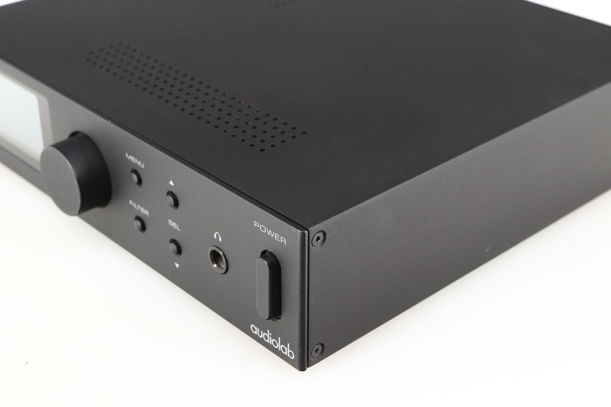 Front right corner of a used Audiolab M-DAC Digital Analogue Converter in a black finish