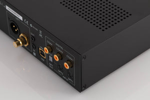 Rear left corner of a used Audiolab M-DAC Digital Analogue Converter in a Black finish