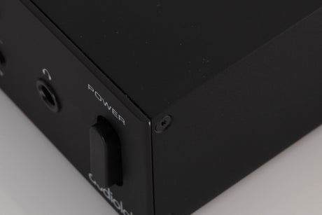 Close up of a used Audiolab M-DAC Digital Analogue Converter in a Black finish showing tiny nick on front left corner