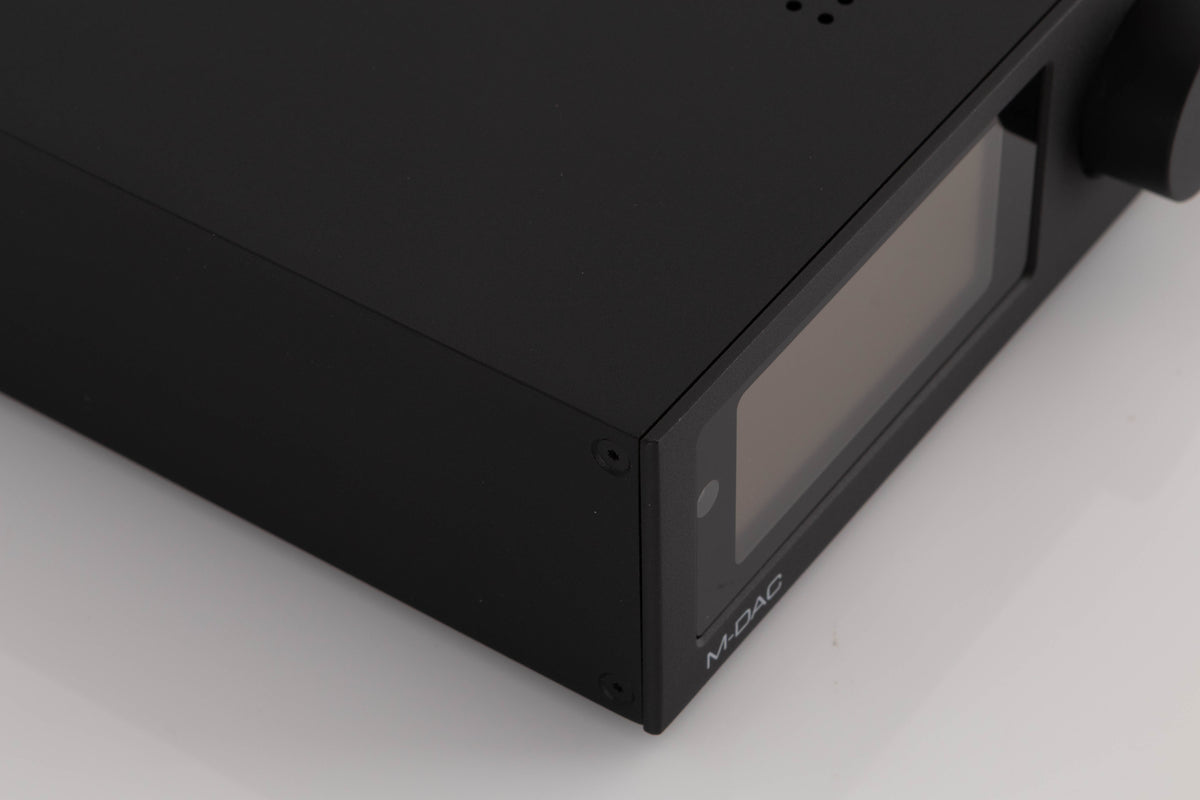 Front left corner of a used Audiolab M-DAC Digital Analogue Converter in a Black finish