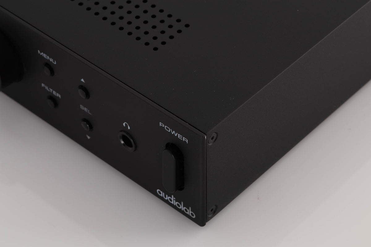 Front right corner of a used Audiolab M-DAC Digital Analogue Converter in a Black finish