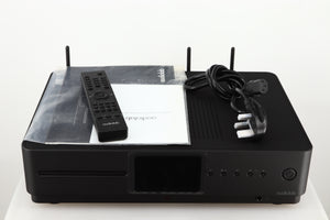 Top of a used Audiolab Omnia Digital Integrated System in a black finish showing Remote, Manual and Mains Cable 