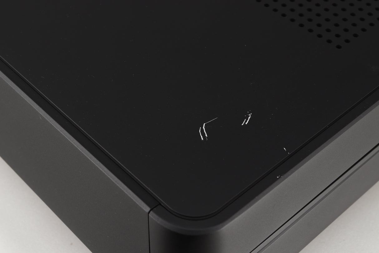 Close up of a used Audiolab Omnia Digital Integrated System in a black finish showing some scratches on top