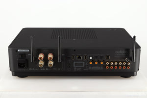 Rear view of a used Audiolab Omnia Digital Integrated System in a black finish showing Mains Input, Phono Inputs, Ethernet Input, Optical Inputs and Speakers Outputs