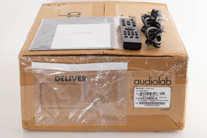 Box of a used Audiolab Omnia Integrated Streaming System in Silver with mains cable, manual, and remote