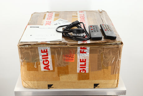 Box of a used Ayre CX-7 CD Player in silver finish showing manual, mains cable, and remotes