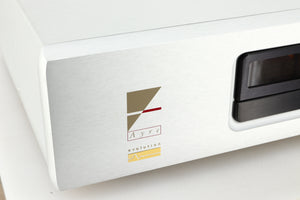 Close up view of a used Ayre CX-7 CD Player in silver finish showing the logo
