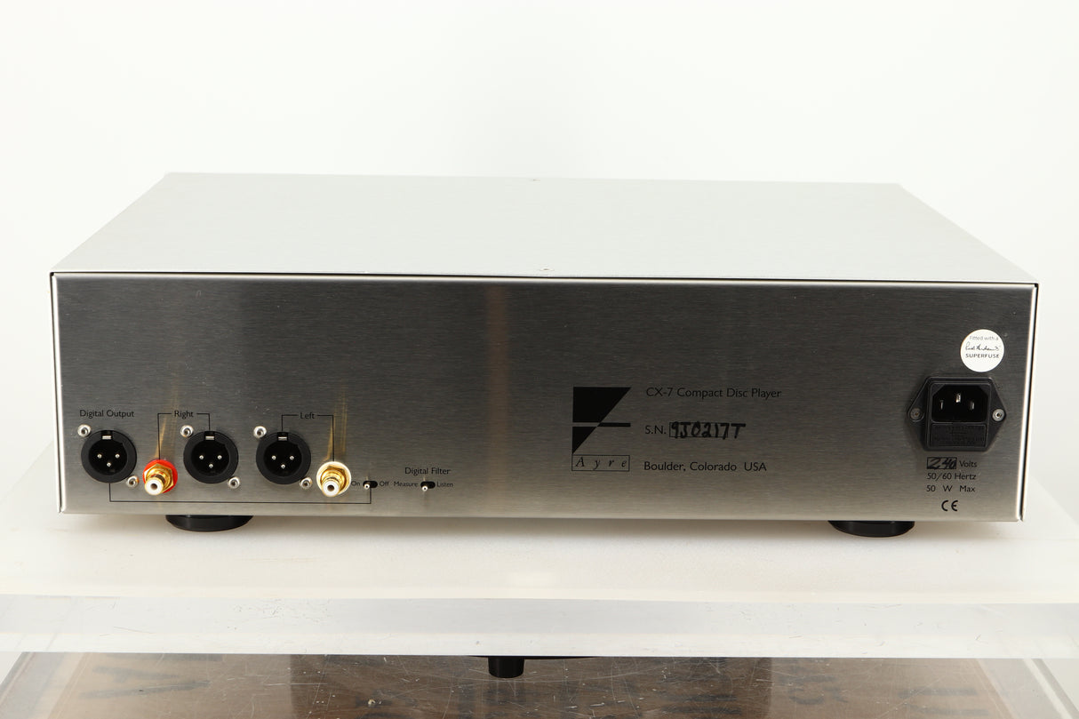 Rear view of a used Ayre CX-7 CD Player in silver finish showing mains input, XLR and RCA outputs