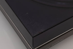 Close up of a used B&O Beogram RX2 Turntable showing some damage on lid