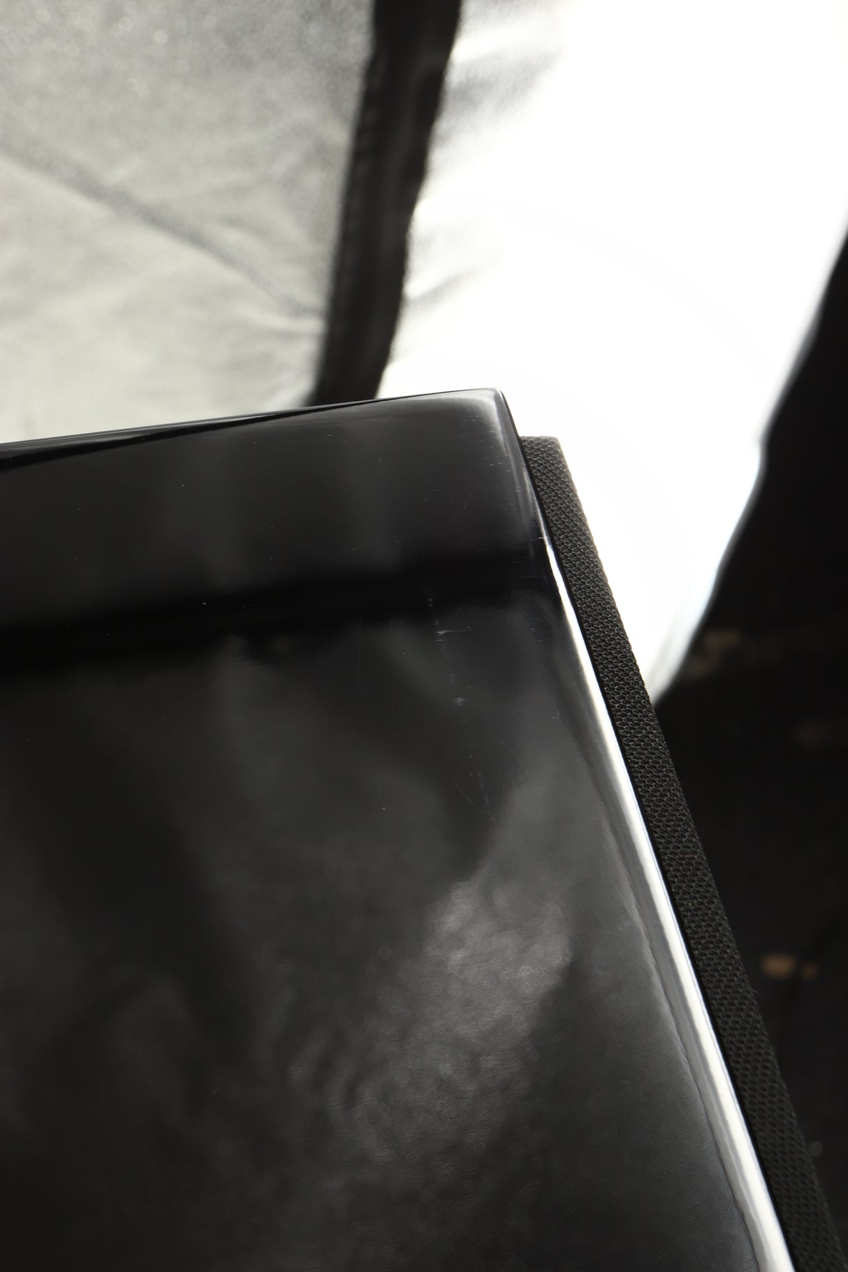Close up view of a used B&W 704 S2 Floorstanding Speakers in Gloss Black showing marks on the top front edge 