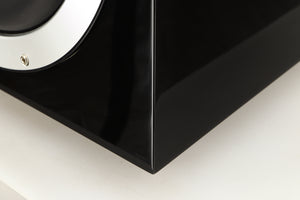 Close up of a used B&W ASW10CM Subwoofer in a gloss black finish showing scratching on fascia