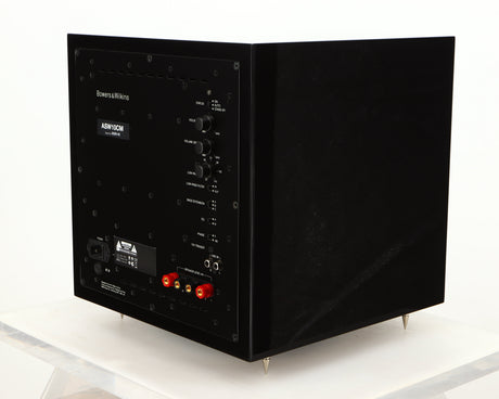 Rear left corner of a used B&W ASW10CM Subwoofer in a gloss black finish