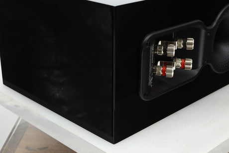 Rear left corner view of a used B&W CM Centre S2 Centre Speaker in Gloss Black finish 