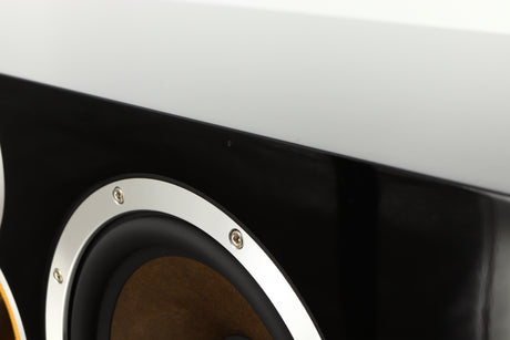 Close up of a used B&W CM Centre 2 Centre Speaker in a black gloss finish showing scratching on fascia top edge