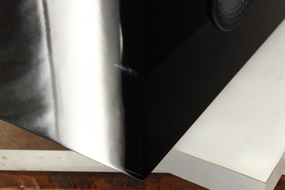 Close up of a used B&W CM Centre 2 Centre Speaker in a black gloss finish showing scratching on rear right corner