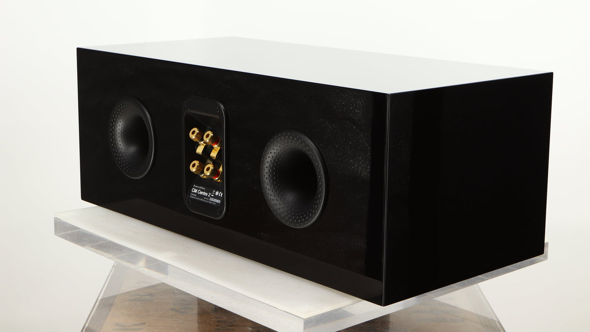 Rear left corner of a used B&W CM Centre 2 Centre Speaker in a black gloss finish