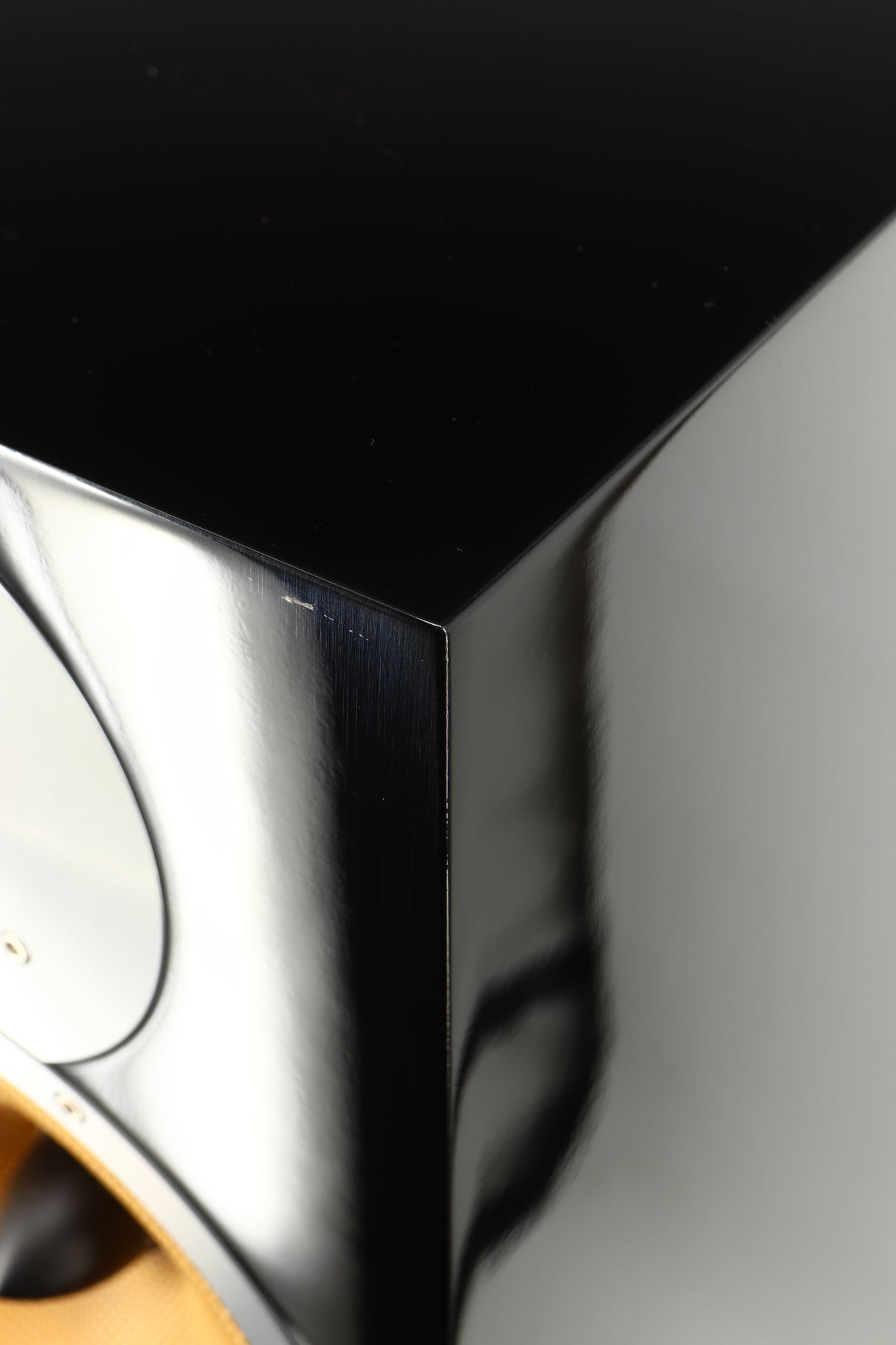 Close up of a used B&W CM9 Floorstanding Speaker in a gloss black finish showing some scratching on front top edge