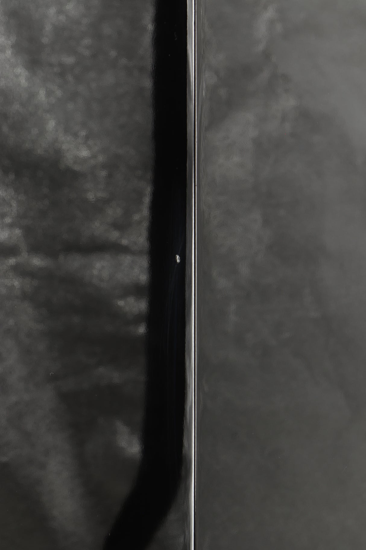 Close up of a used B&W CM9 Floorstanding Speaker in a gloss black finish showing small chip on rear right corner
