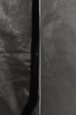 Close up of a used B&W CM9 Floorstanding Speaker in a gloss black finish showing small chip on rear right corner