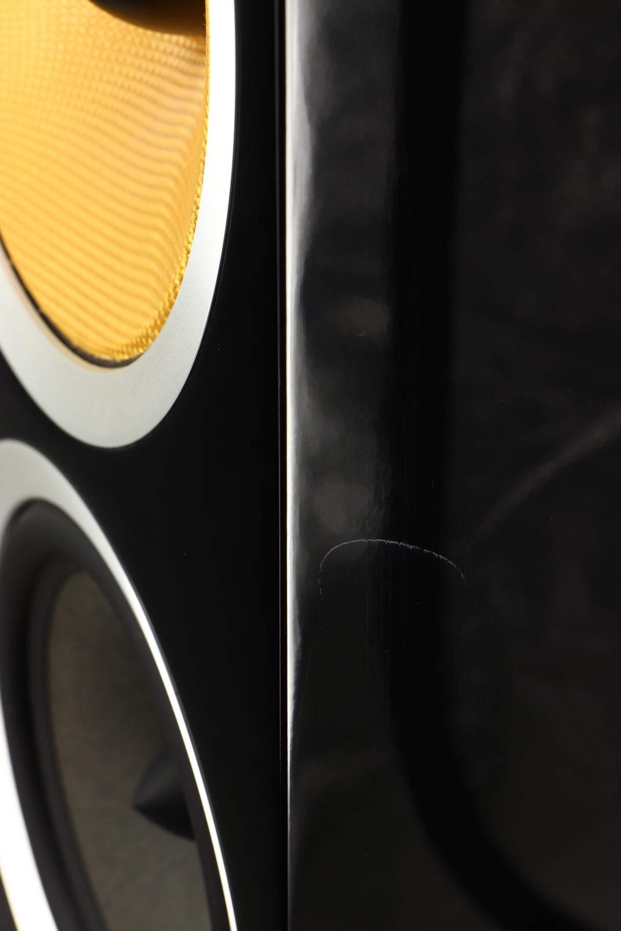 Close up of a used B&W CM9 S2 Floorstanding Speaker in a gloss black finish showing scratching on cabinet