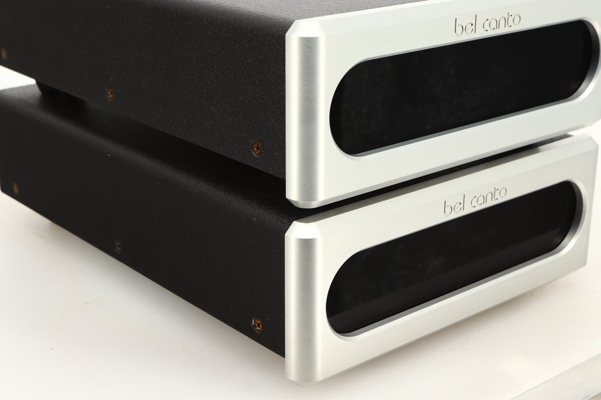 Front left corner view of a used pair of Bel Canto REF600M Monoblock Power Amplifiers in Silver finish