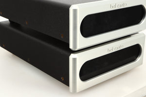 Front left corner view of a used pair of Bel Canto REF600M Monoblock Power Amplifiers in Silver finish