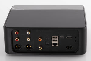 Rear view of a used Bluesound Node Icon Music Streamer in a Black finish showing Power Input, HDMI Input, USB Inputs, Optical Input, Optical Output, Phono Inputs, Phono Outputs, XLR Outputs and Coaxial Output